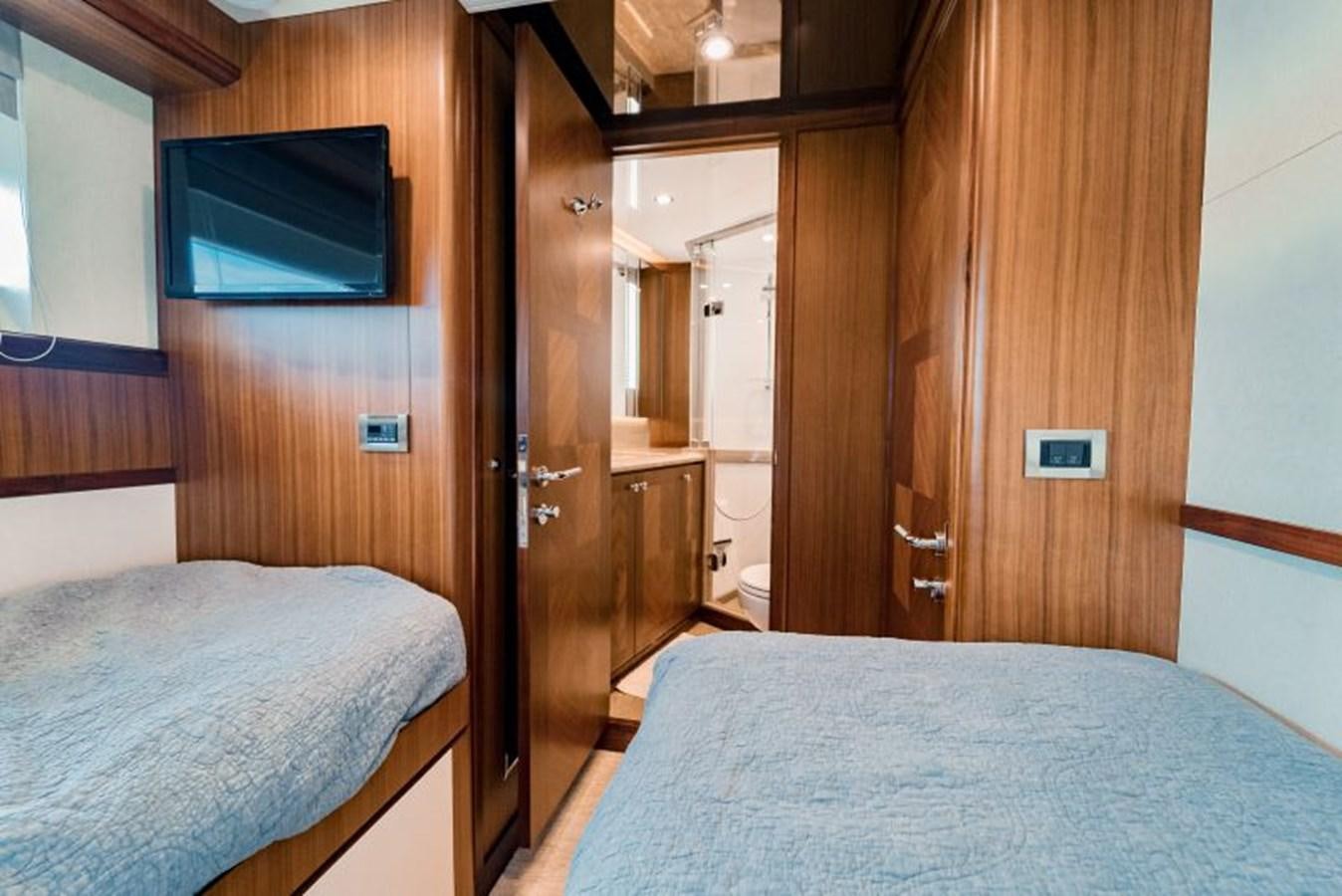 a bedroom with a bed and a television aboard SWEET SALT Yacht for Sale