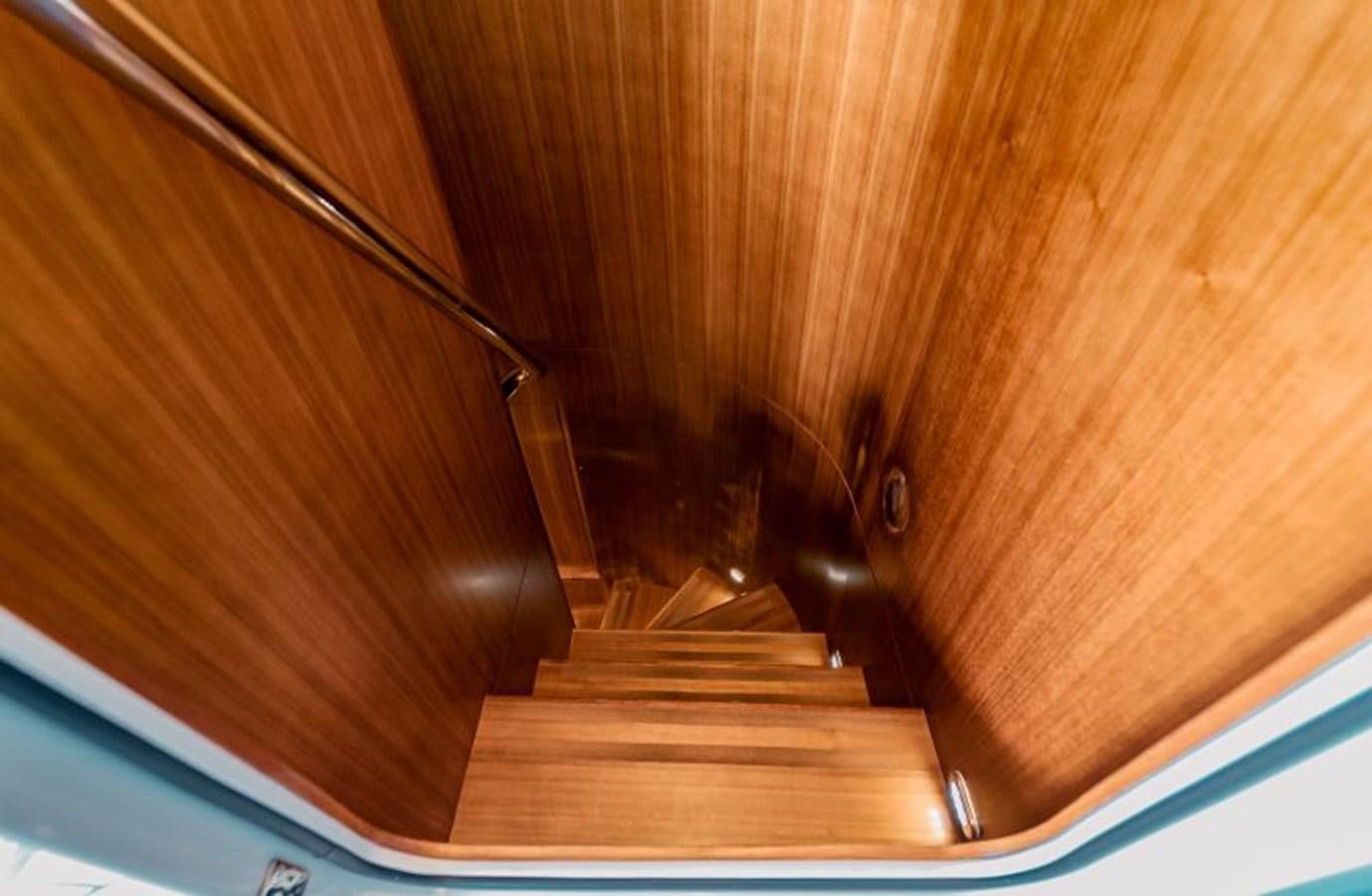 a wooden staircase with a metal railing aboard SWEET SALT Yacht for Sale