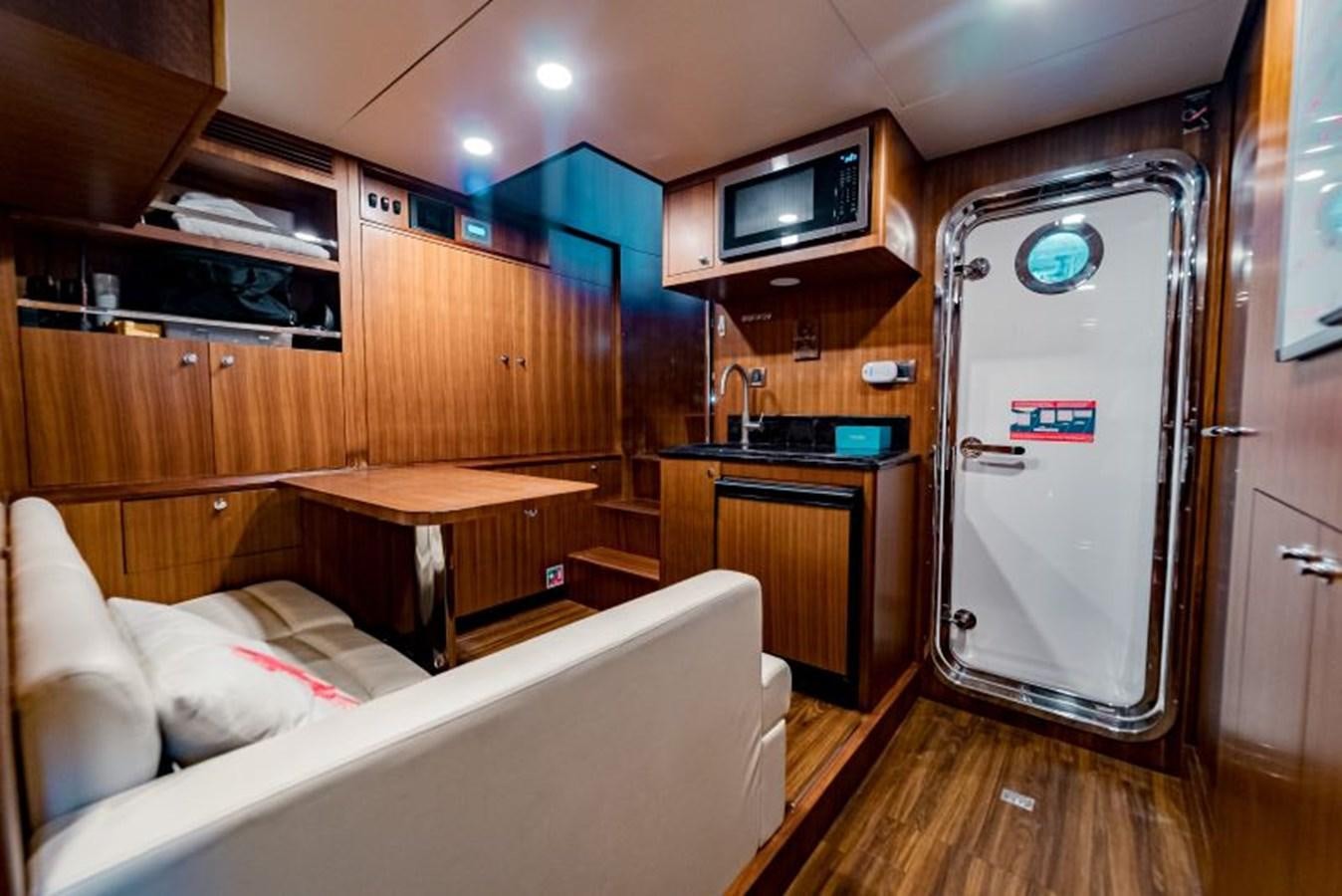 a room with a bed and a table aboard SWEET SALT Yacht for Sale