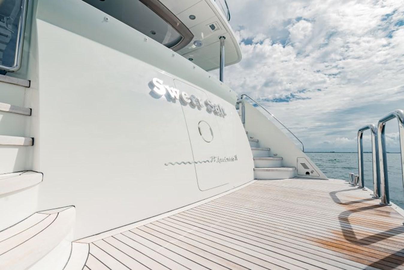 a white boat on a deck aboard SWEET SALT Yacht for Sale