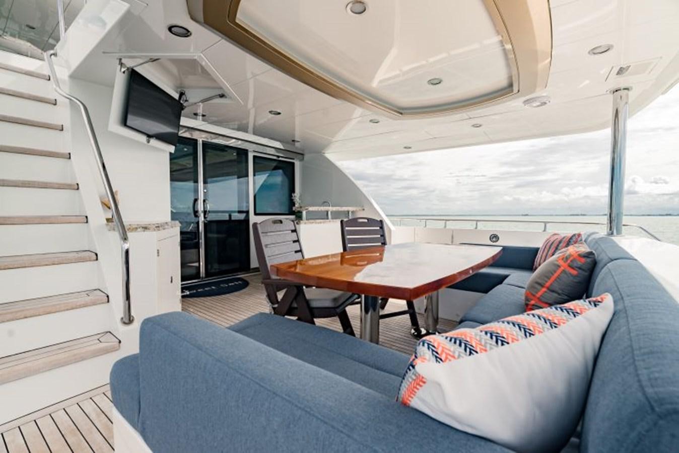 a boat with a table and couch aboard SWEET SALT Yacht for Sale