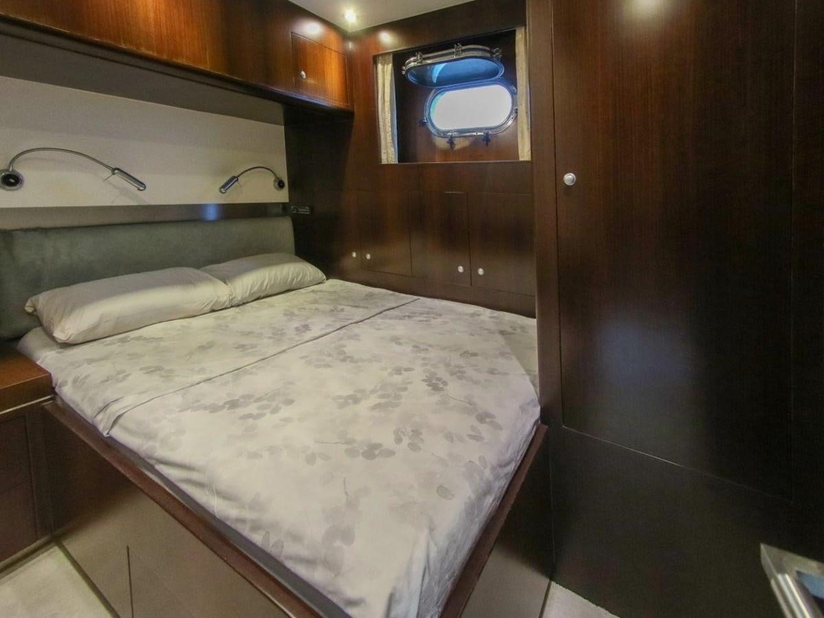 a bed with a white sheet aboard POCO LOCO Yacht for Sale