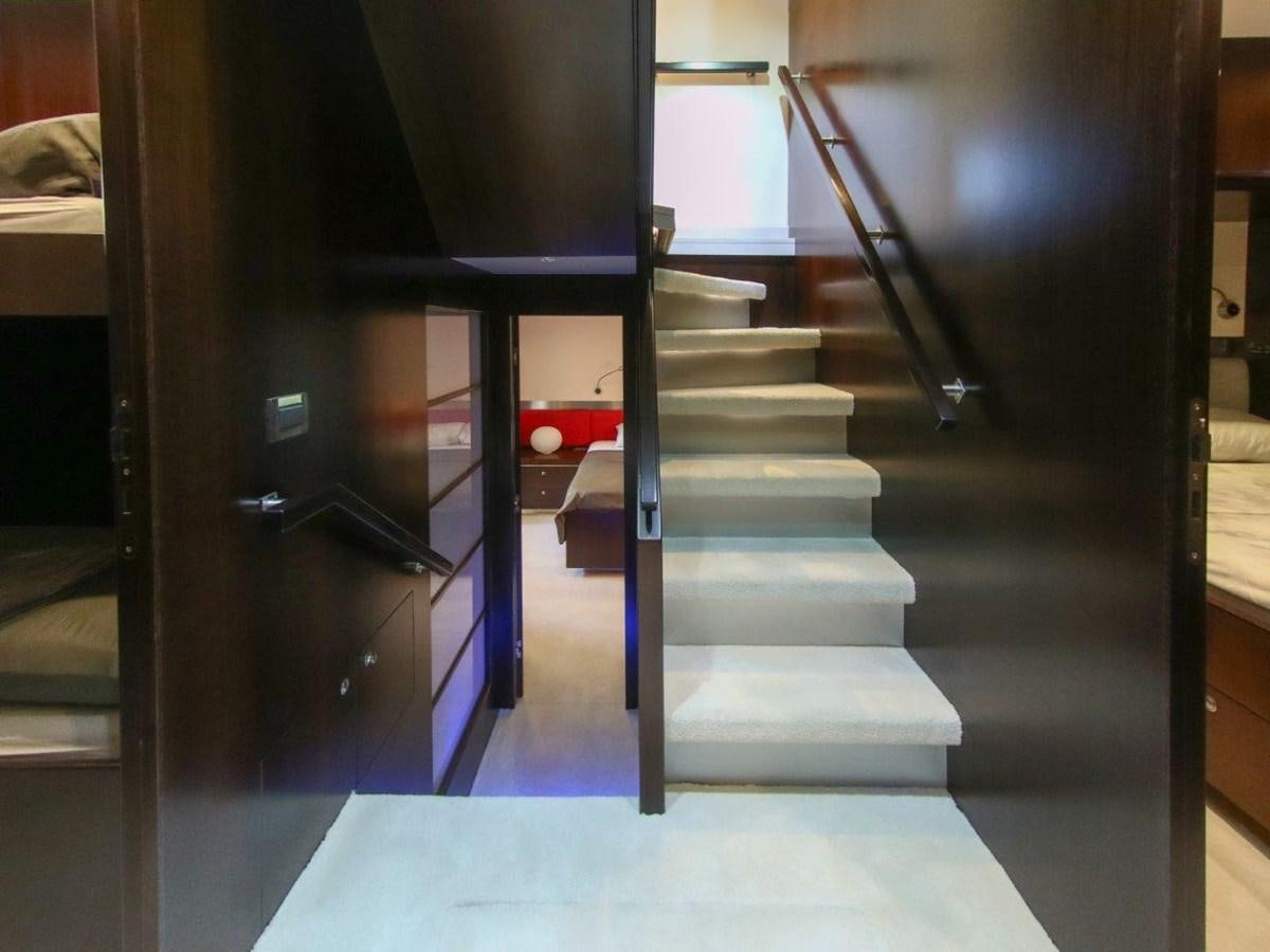 a dark room with a staircase aboard POCO LOCO Yacht for Sale