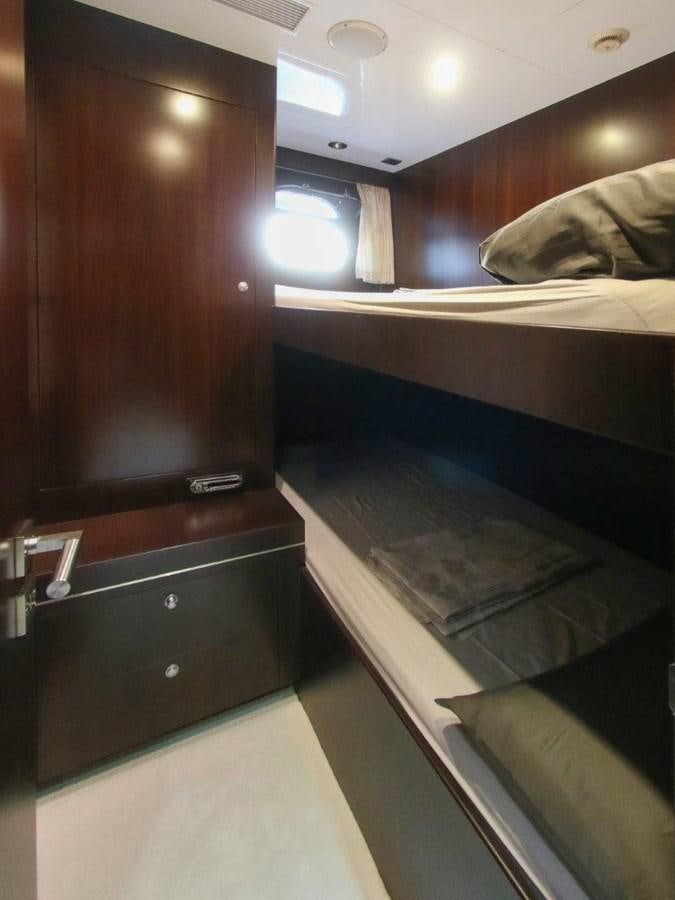 a room with a bed and a desk aboard POCO LOCO Yacht for Sale