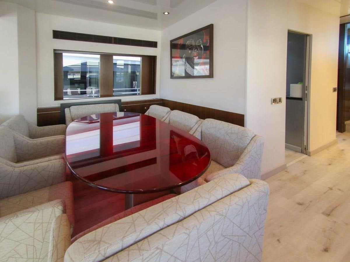 a living room with a couch and a television aboard POCO LOCO Yacht for Sale