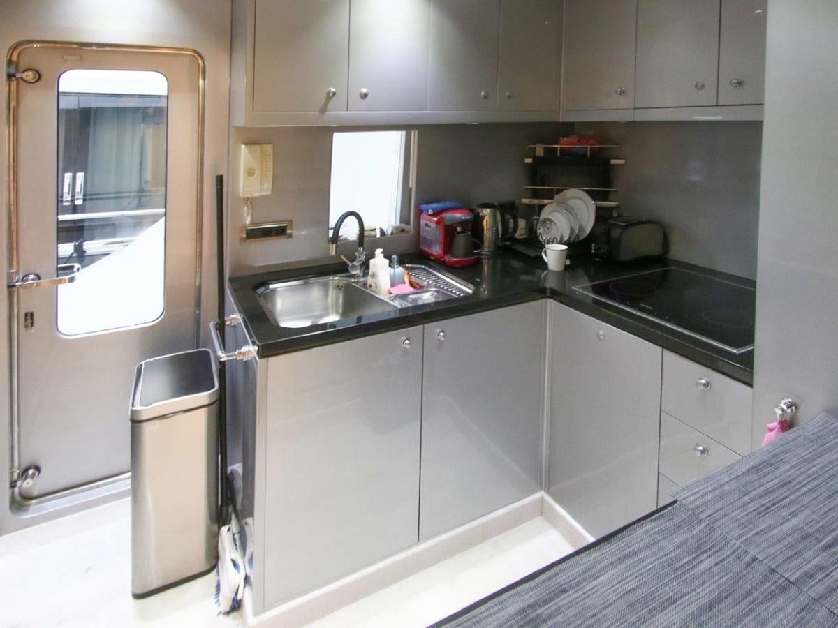 a kitchen with a sink and cabinets aboard POCO LOCO Yacht for Sale
