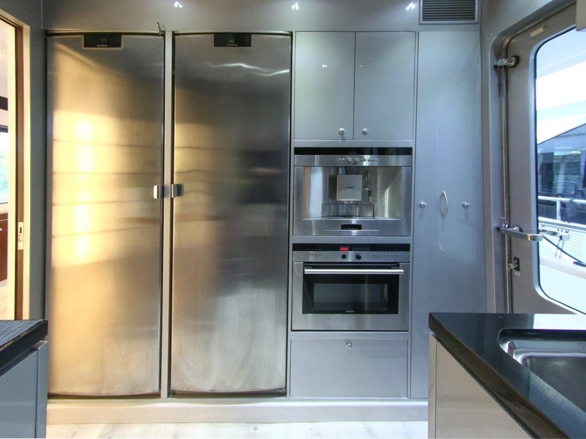 a kitchen with stainless steel appliances aboard POCO LOCO Yacht for Sale