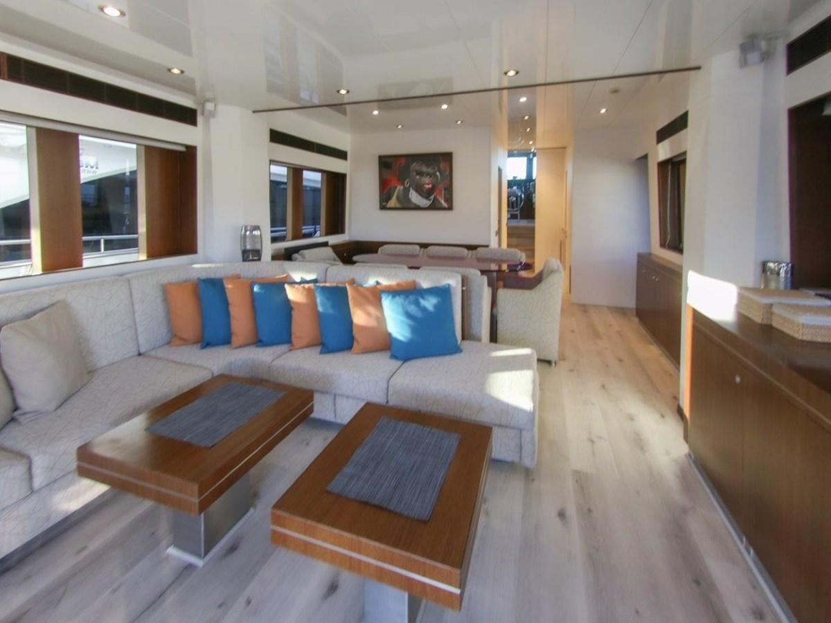 a living room with a couch and a table aboard POCO LOCO Yacht for Sale
