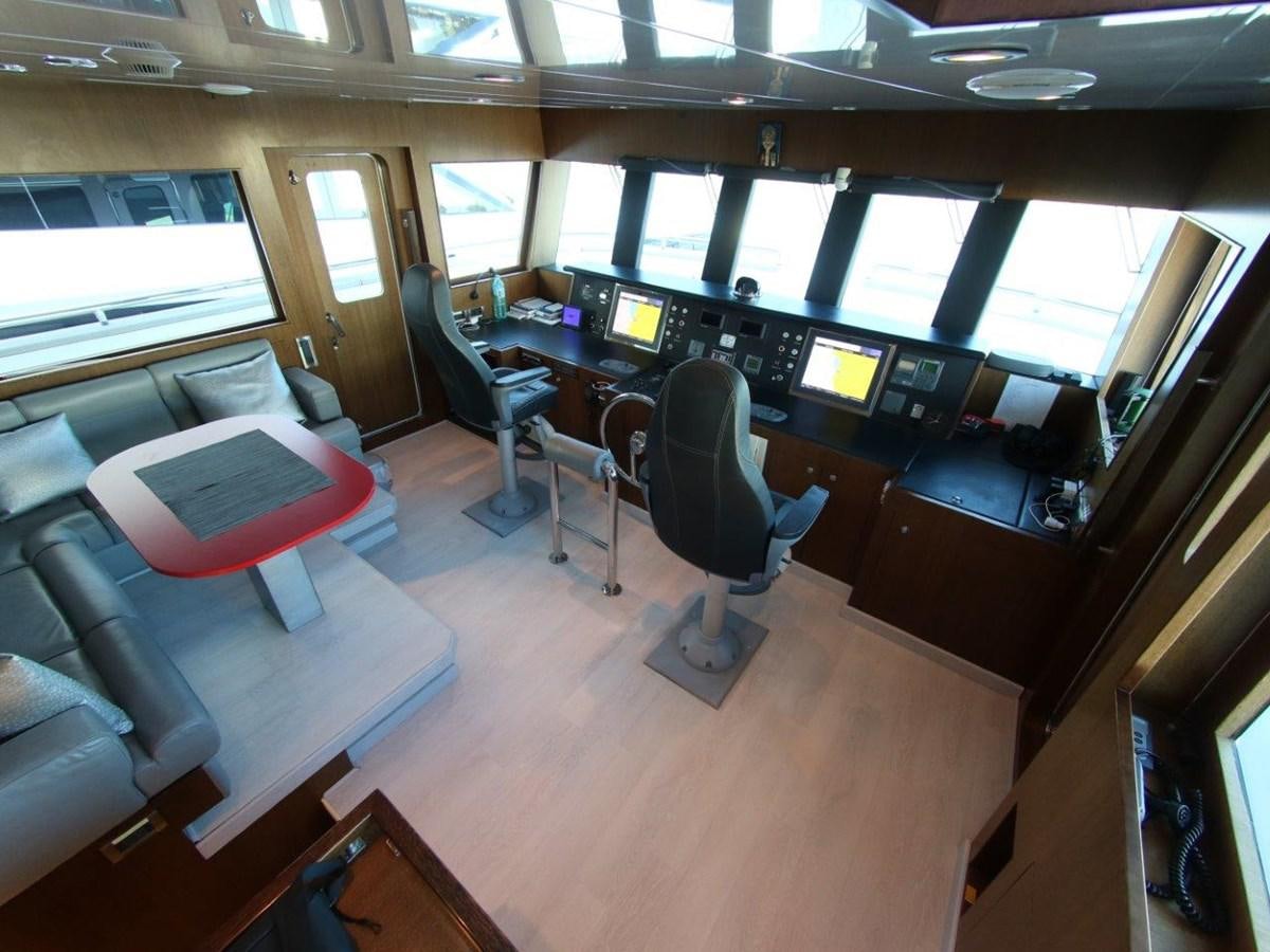 a room with a desk and chairs aboard POCO LOCO Yacht for Sale