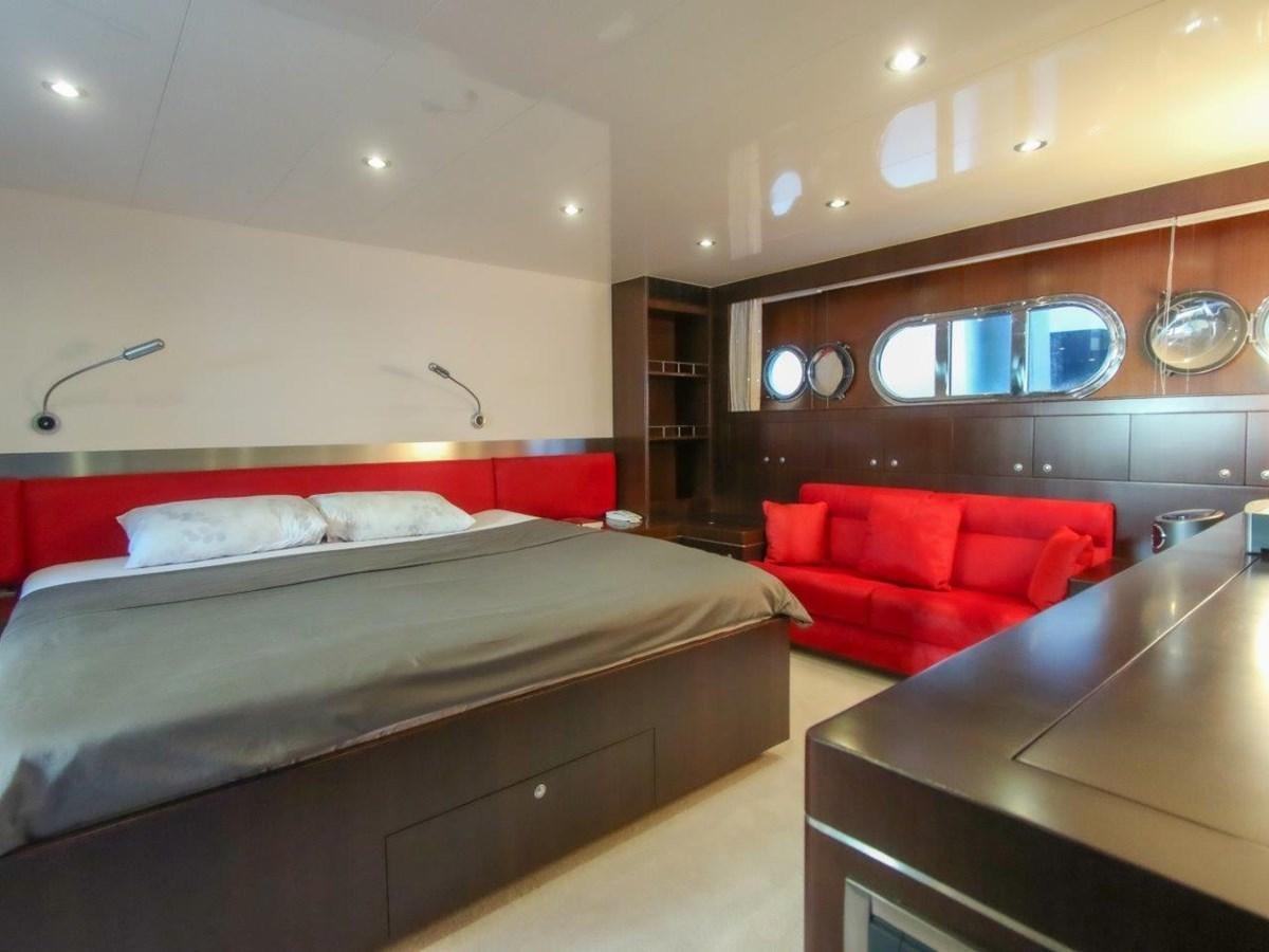 a room with a bed and a couch aboard POCO LOCO Yacht for Sale