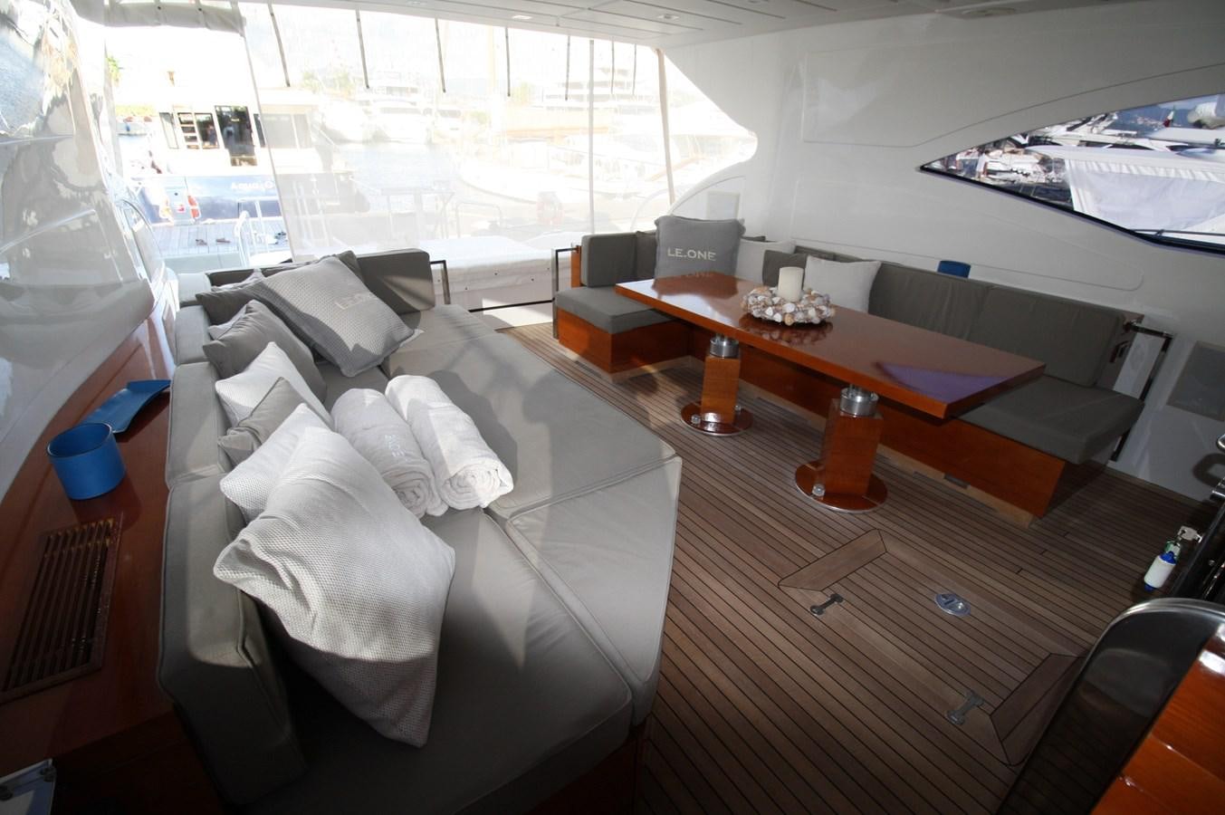 a room with a couch and a table aboard LE.ONE Yacht for Sale