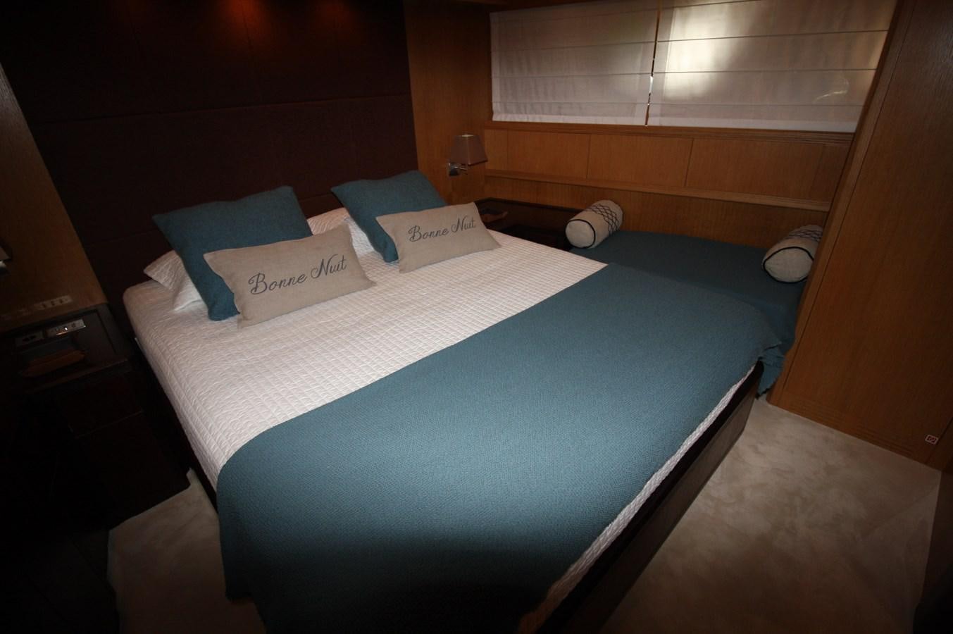 a bed with blue sheets aboard LE.ONE Yacht for Sale