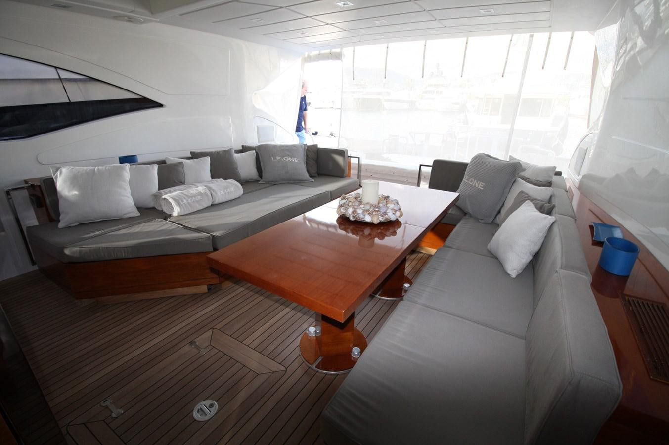 a living room with a couch and a coffee table aboard LE.ONE Yacht for Sale