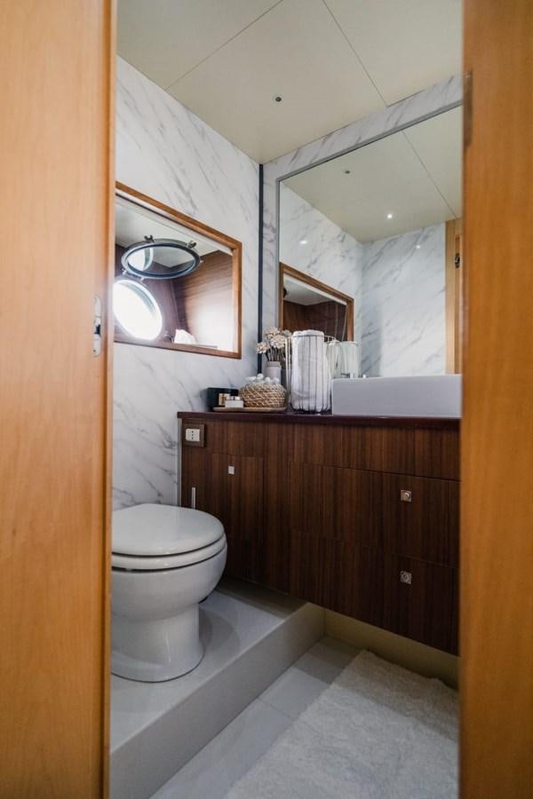 a bathroom with a mirror and a toilet aboard F68 Yacht for Sale