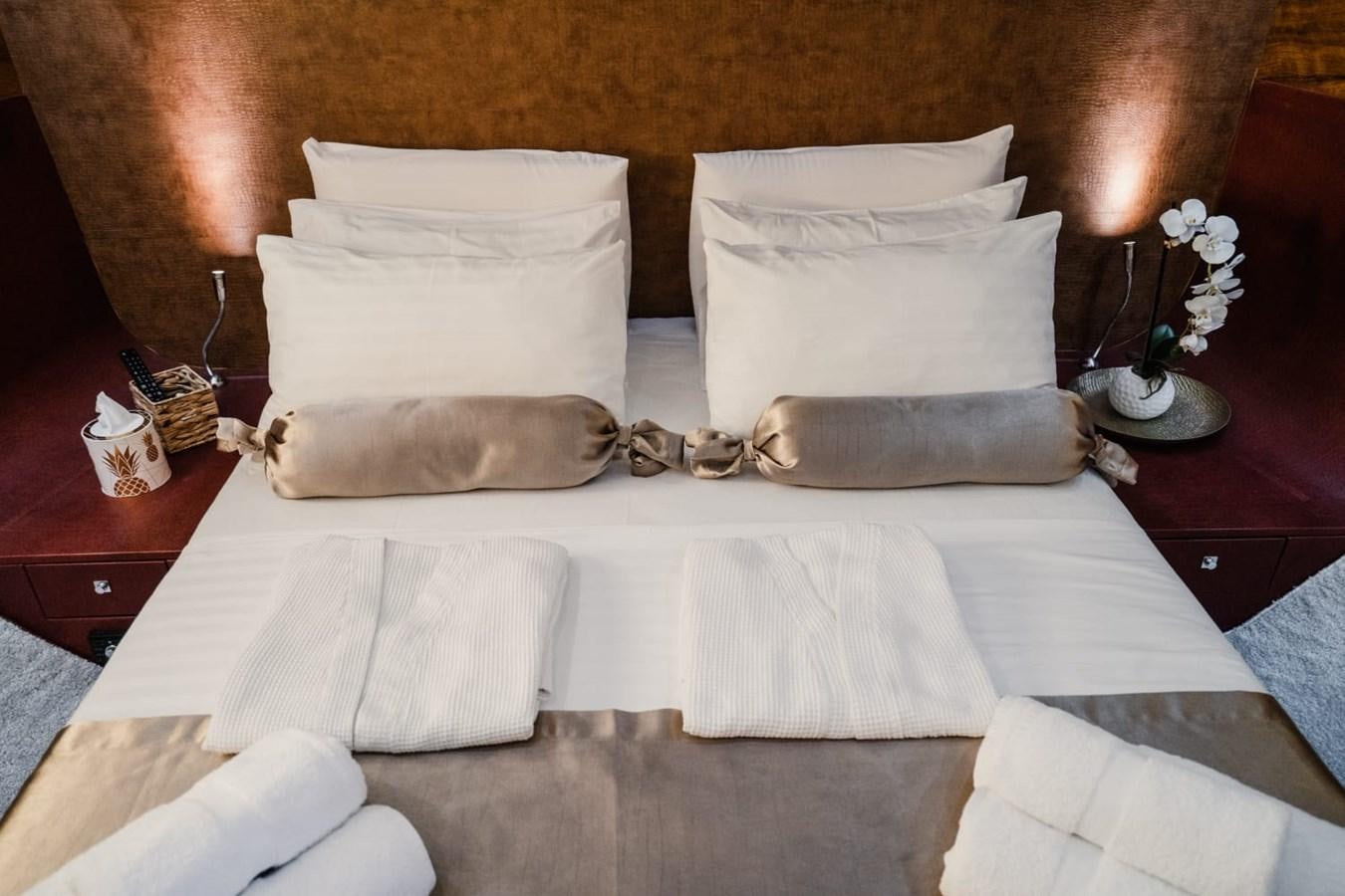 a bed with pillows aboard F68 Yacht for Sale
