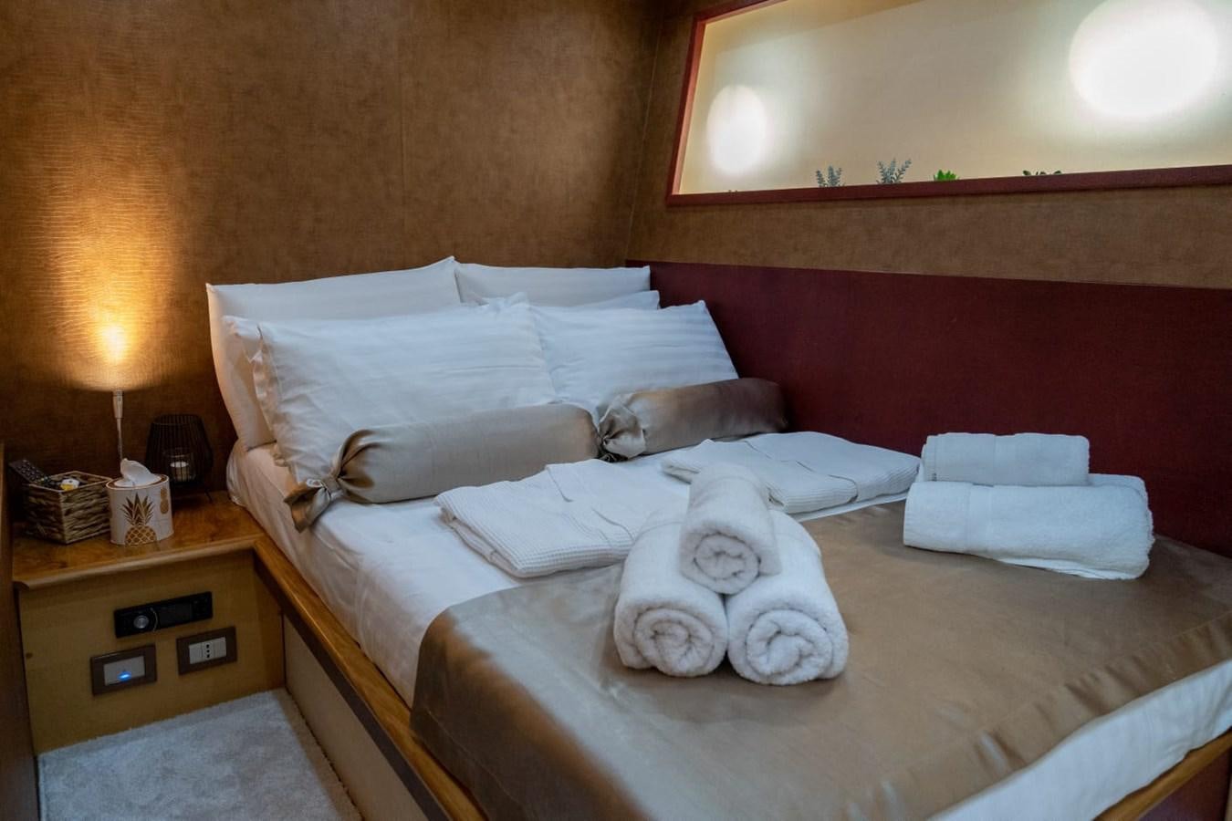 a bed with white pillows aboard F68 Yacht for Sale