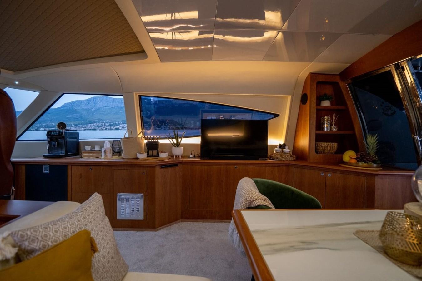 a living room with a large television aboard F68 Yacht for Sale