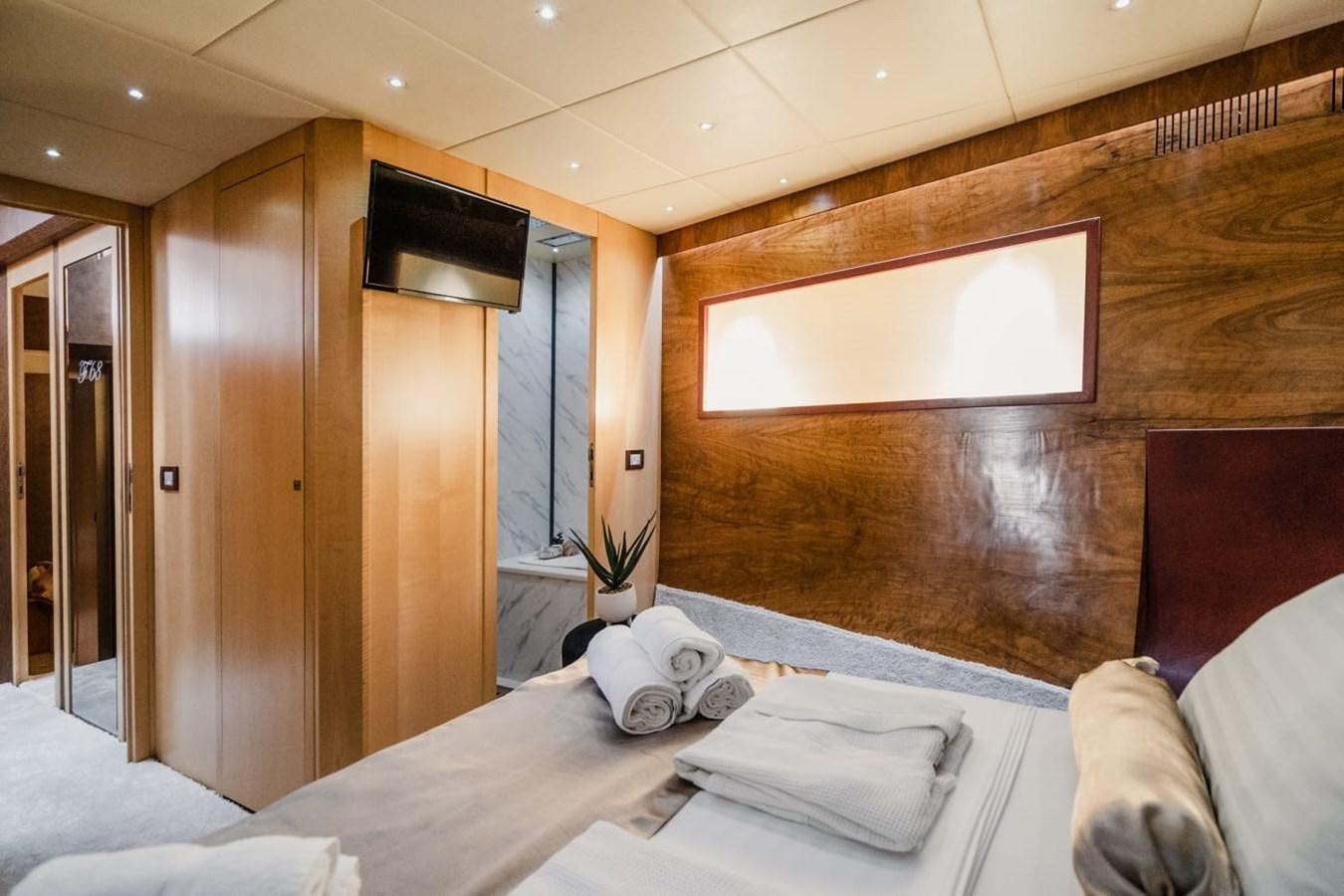 a room with a bed and a television aboard F68 Yacht for Sale