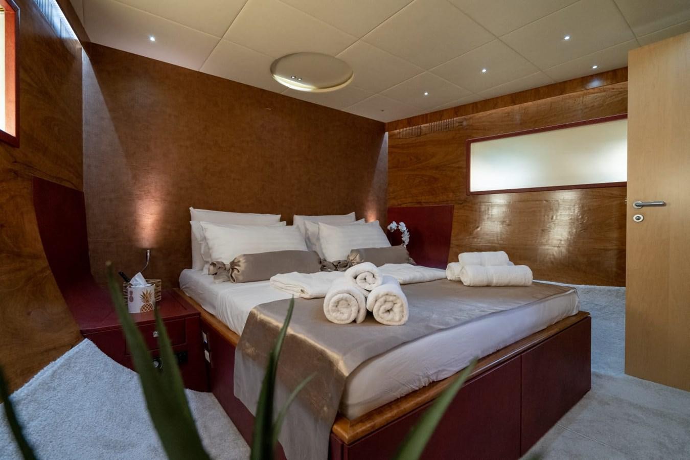 a room with a bed and a table aboard F68 Yacht for Sale