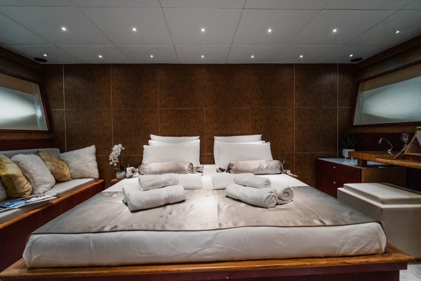 a bed with a white bed spread aboard F68 Yacht for Sale