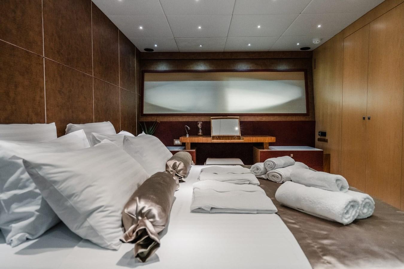 a person lying on a bed aboard F68 Yacht for Sale