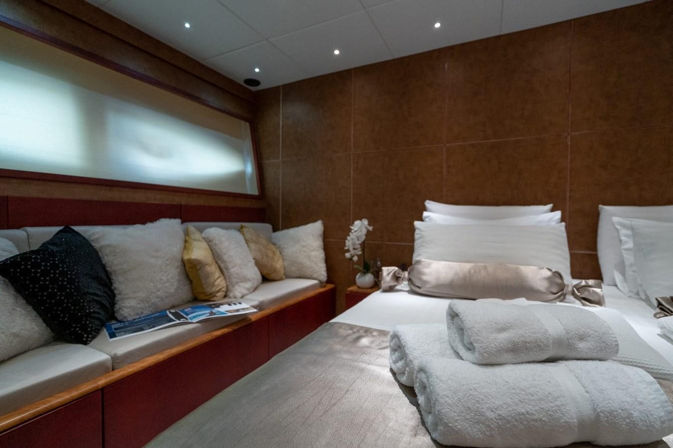a room with a bed and a couch aboard F68 Yacht for Sale