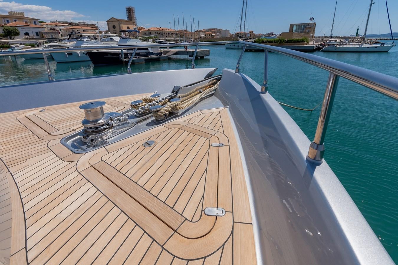 a wooden deck with a metal railing and a metal object on it aboard APHRODITE Yacht for Sale