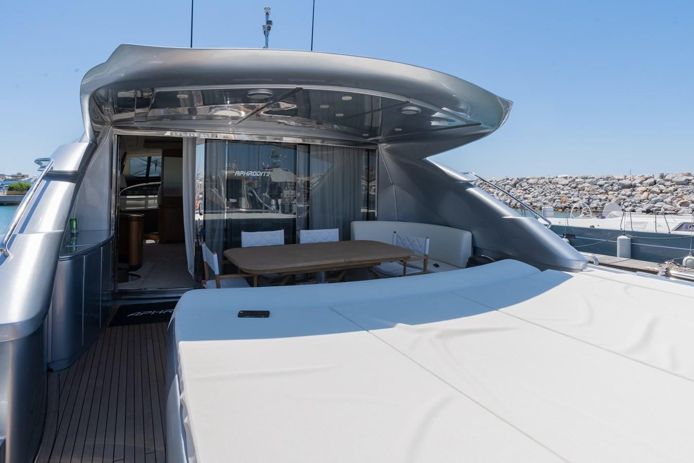a covered patio with a table and chairs aboard APHRODITE Yacht for Sale