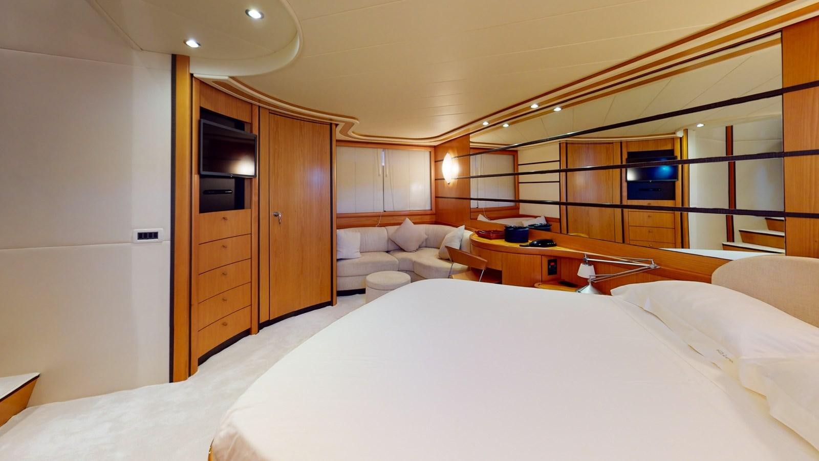 a room with a bed and a television aboard APHRODITE Yacht for Sale