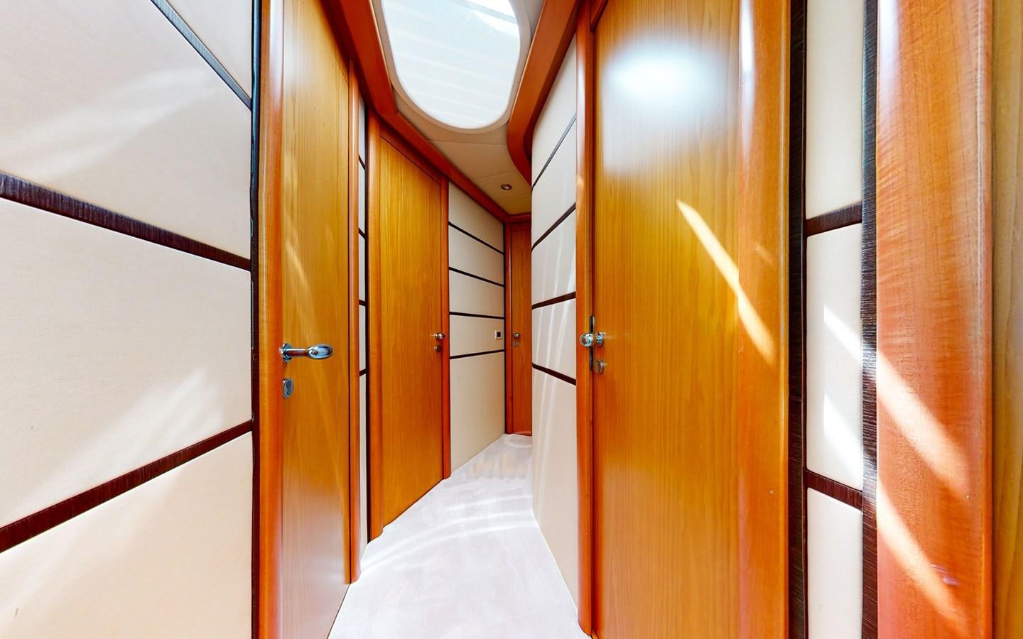 a room with a bed and a door aboard APHRODITE Yacht for Sale