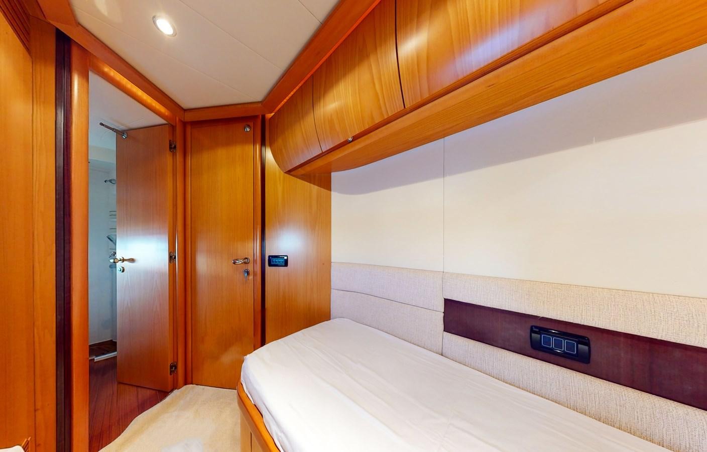 a room with a bed and a door aboard APHRODITE Yacht for Sale