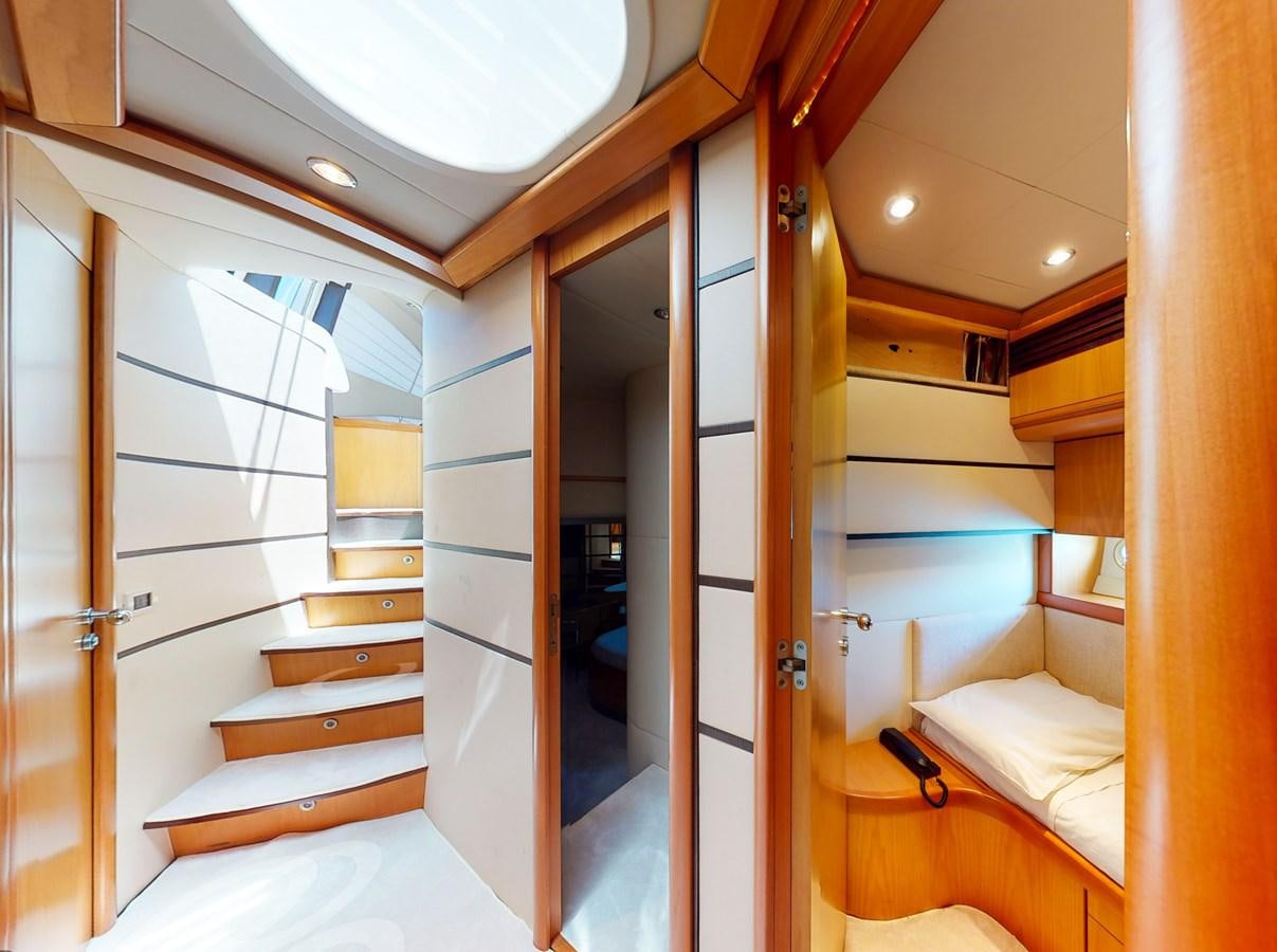 a room with a bed and a door aboard APHRODITE Yacht for Sale