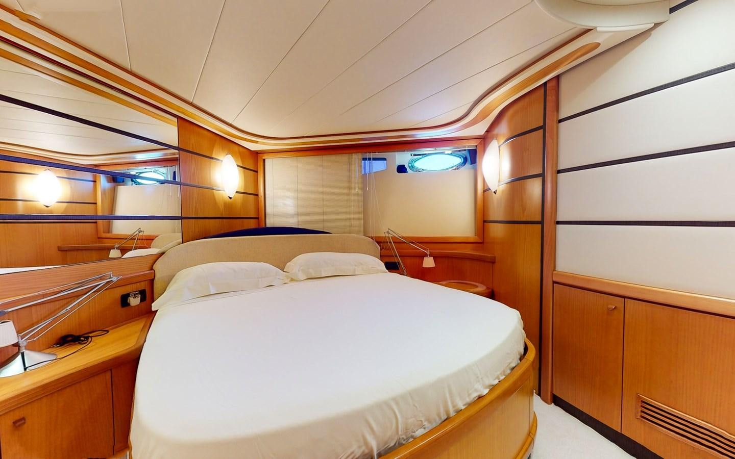 a room with a bed and a desk aboard APHRODITE Yacht for Sale