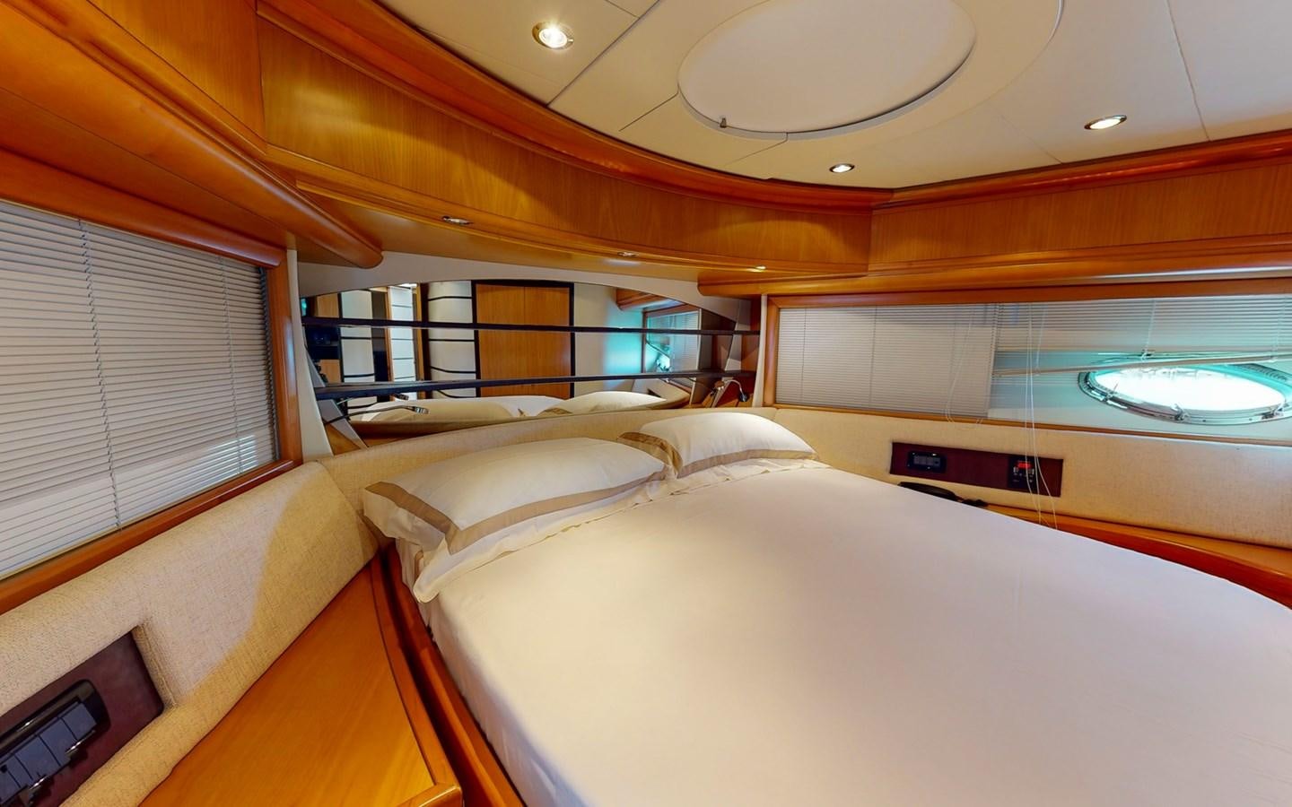 a room with a bed and a window aboard APHRODITE Yacht for Sale