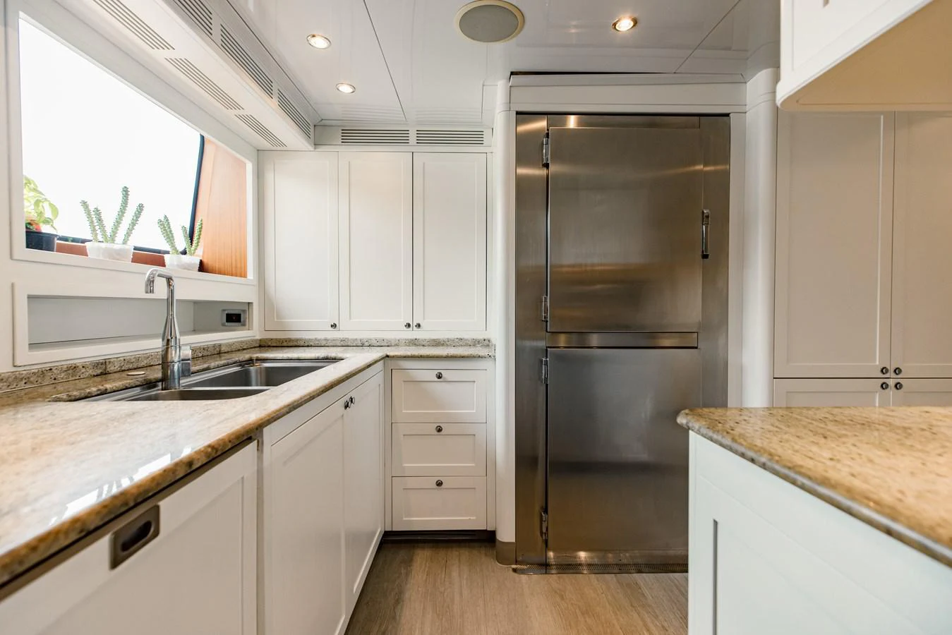 a kitchen with a refrigerator and sink aboard MAMMA MIA Yacht for Sale