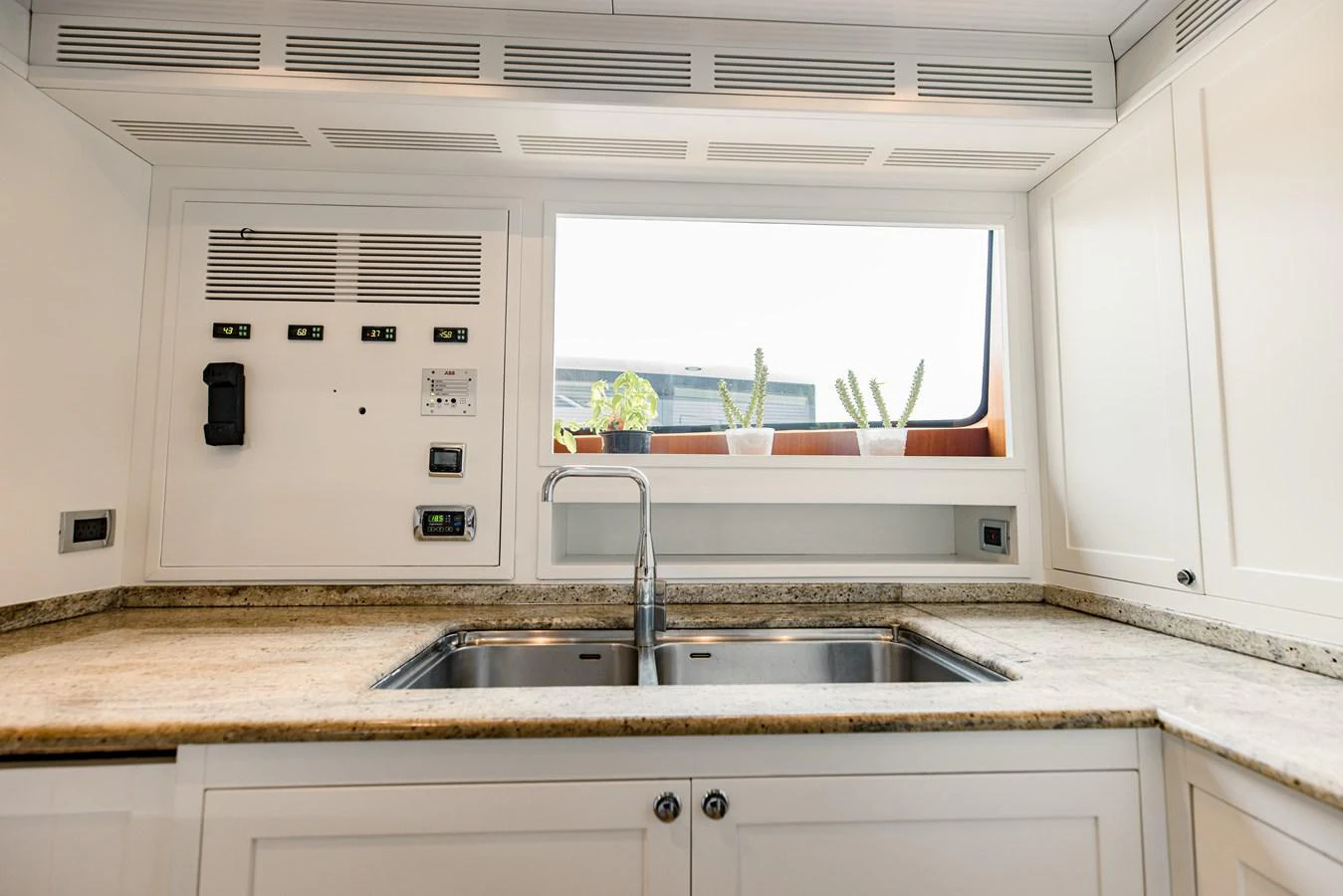 a kitchen with a sink and a window aboard MAMMA MIA Yacht for Sale