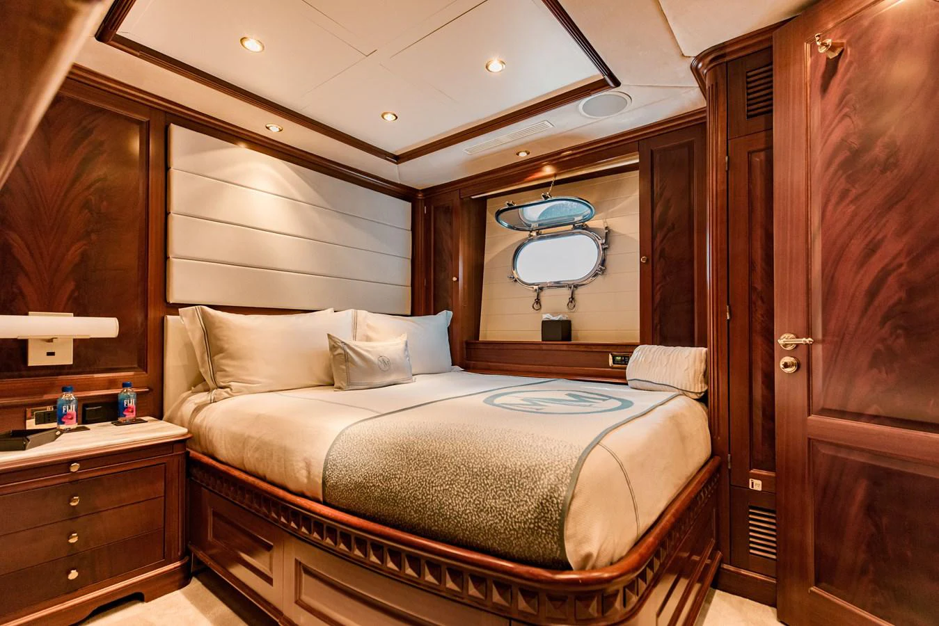 a bed with a round mirror above it aboard MAMMA MIA Yacht for Sale