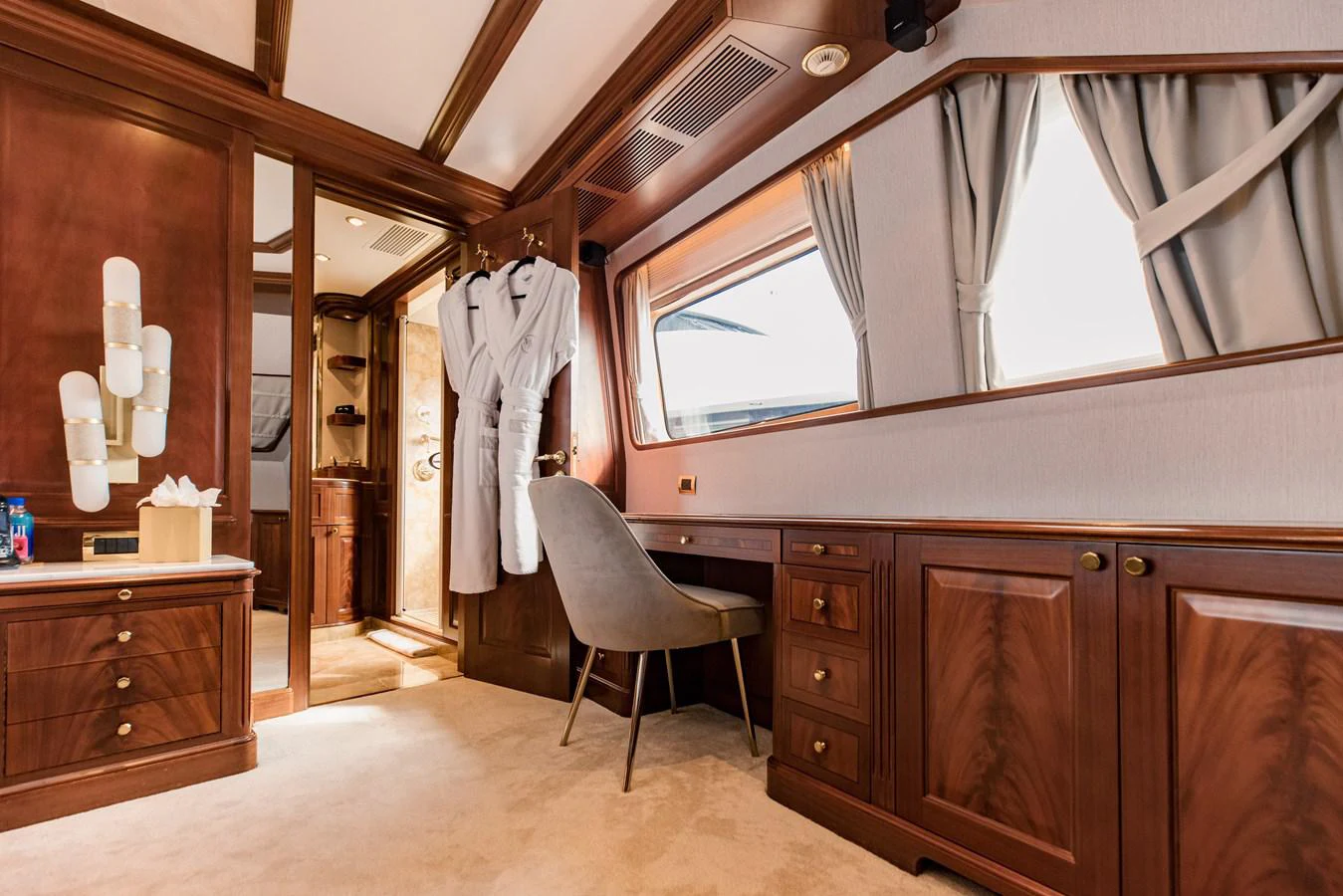 a room with wooden cabinets and a chair and a window aboard MAMMA MIA Yacht for Sale