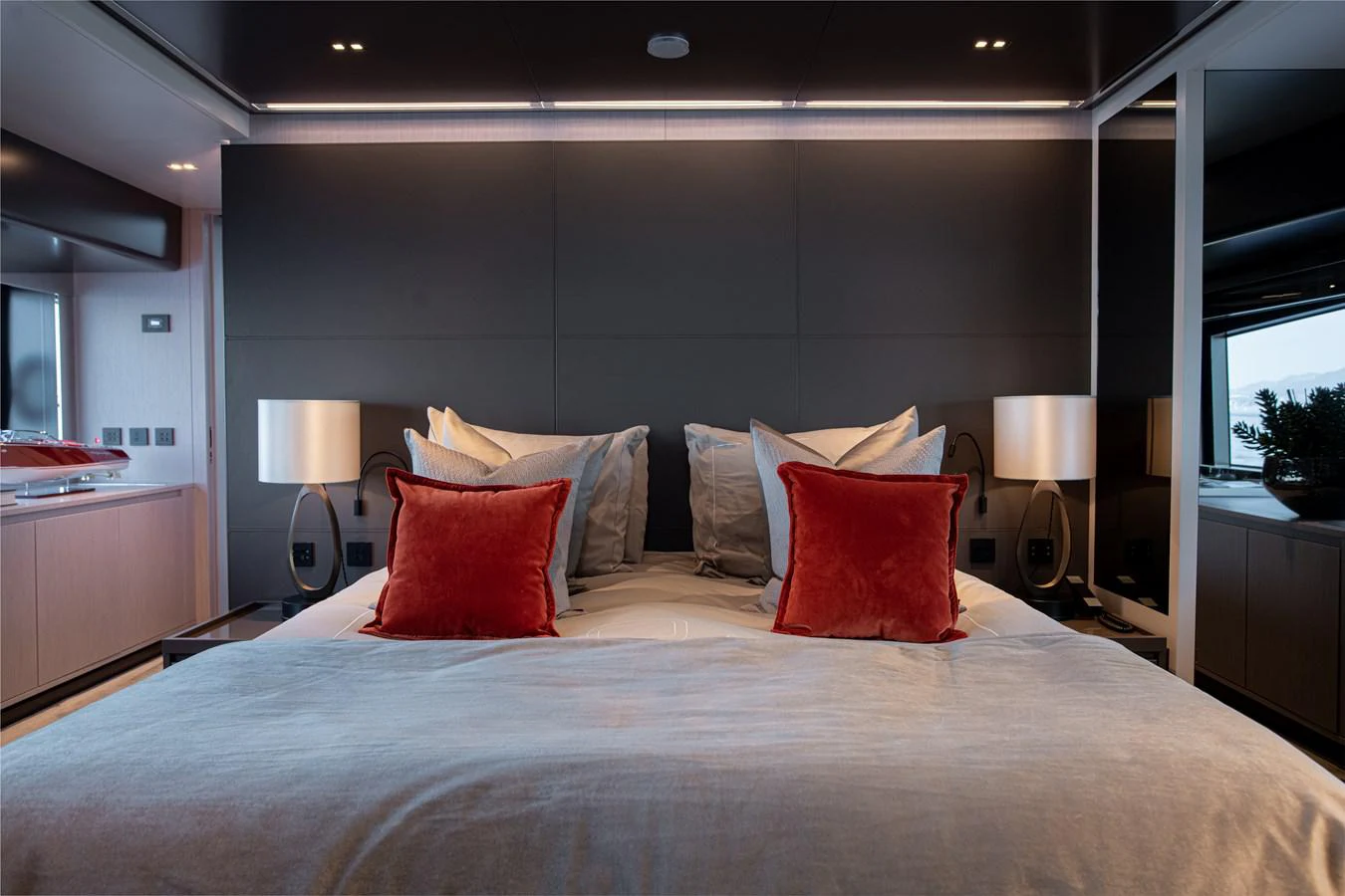 a bed with pillows on it aboard O4 Yacht for Sale