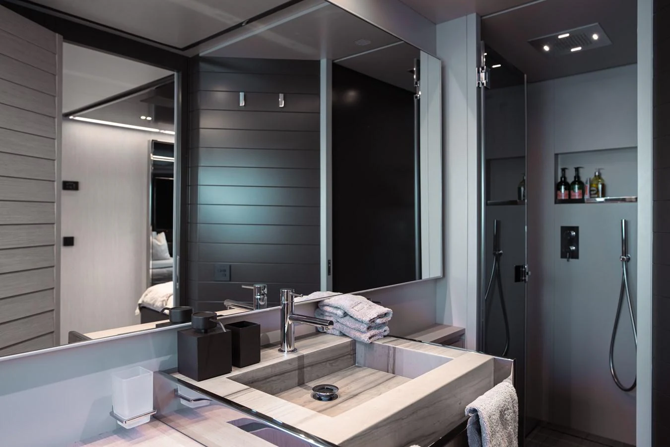 a bathroom with a countertop sink and a mirror aboard O4 Yacht for Sale