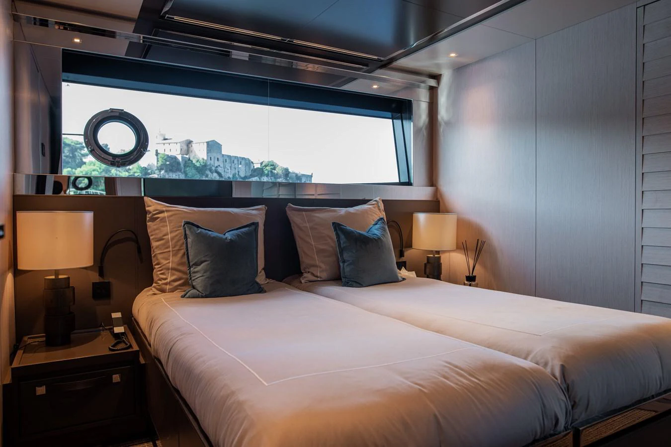 a bed with a large window aboard O4 Yacht for Sale
