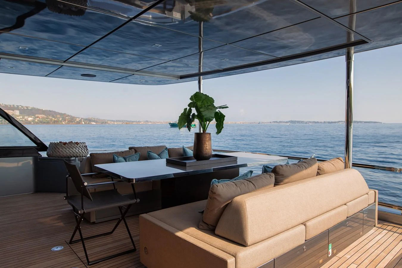 a table and chairs on a deck aboard O4 Yacht for Sale