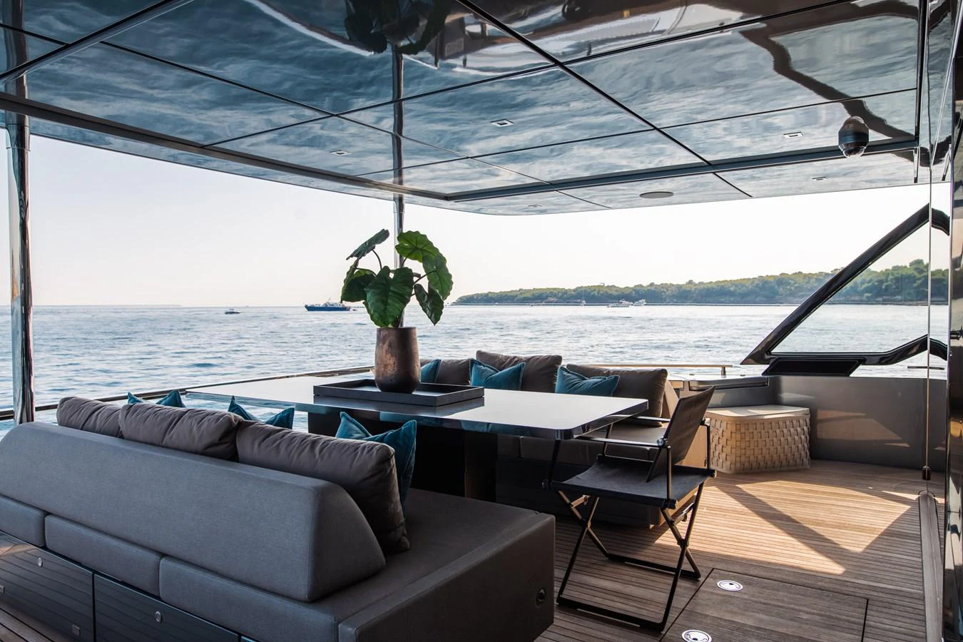 a room with a table and couches aboard O4 Yacht for Sale