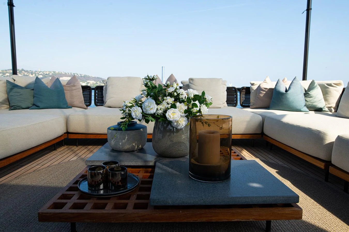 a table with a glass of beer on it in front of a couch aboard O4 Yacht for Sale