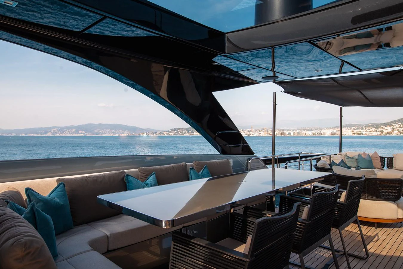 a lounge area with a large body of water in the background aboard O4 Yacht for Sale