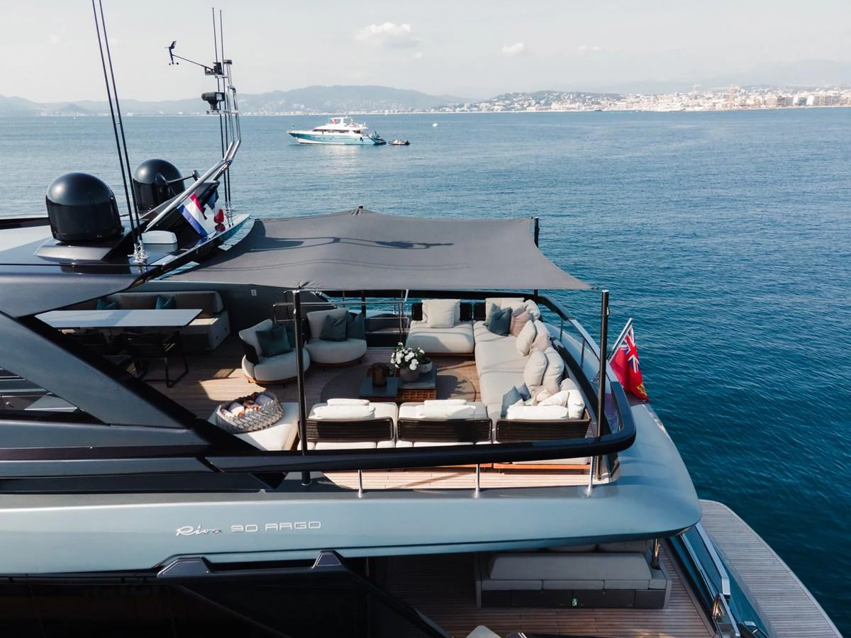 a boat with a flag on the front aboard O4 Yacht for Sale
