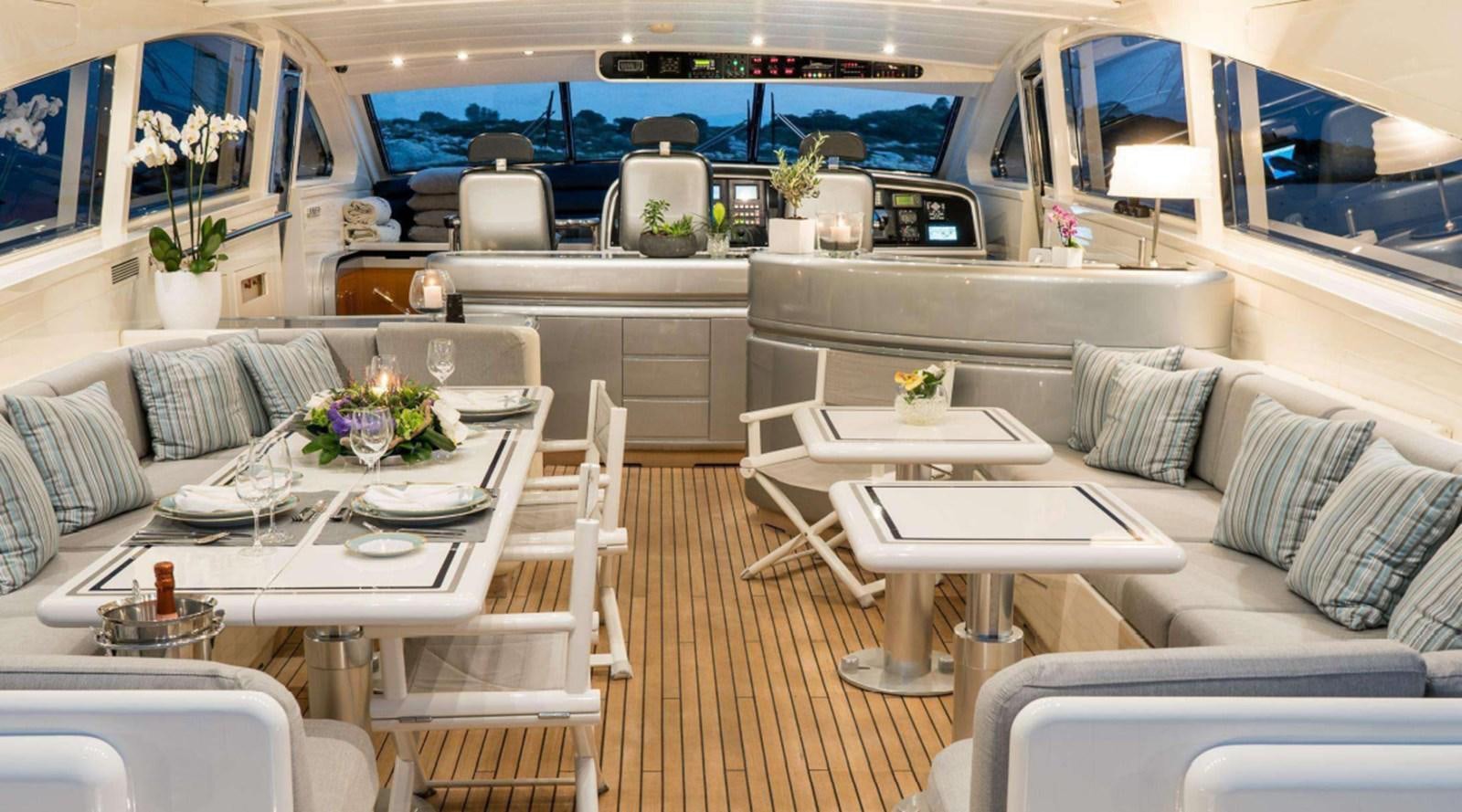 a room with a table chairs and a couch aboard ROMACHRIS II Yacht for Sale