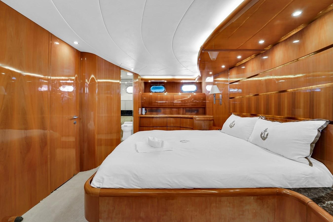 a bed with a white sheet and a wooden wall aboard STAMOS BIEN Yacht for Sale