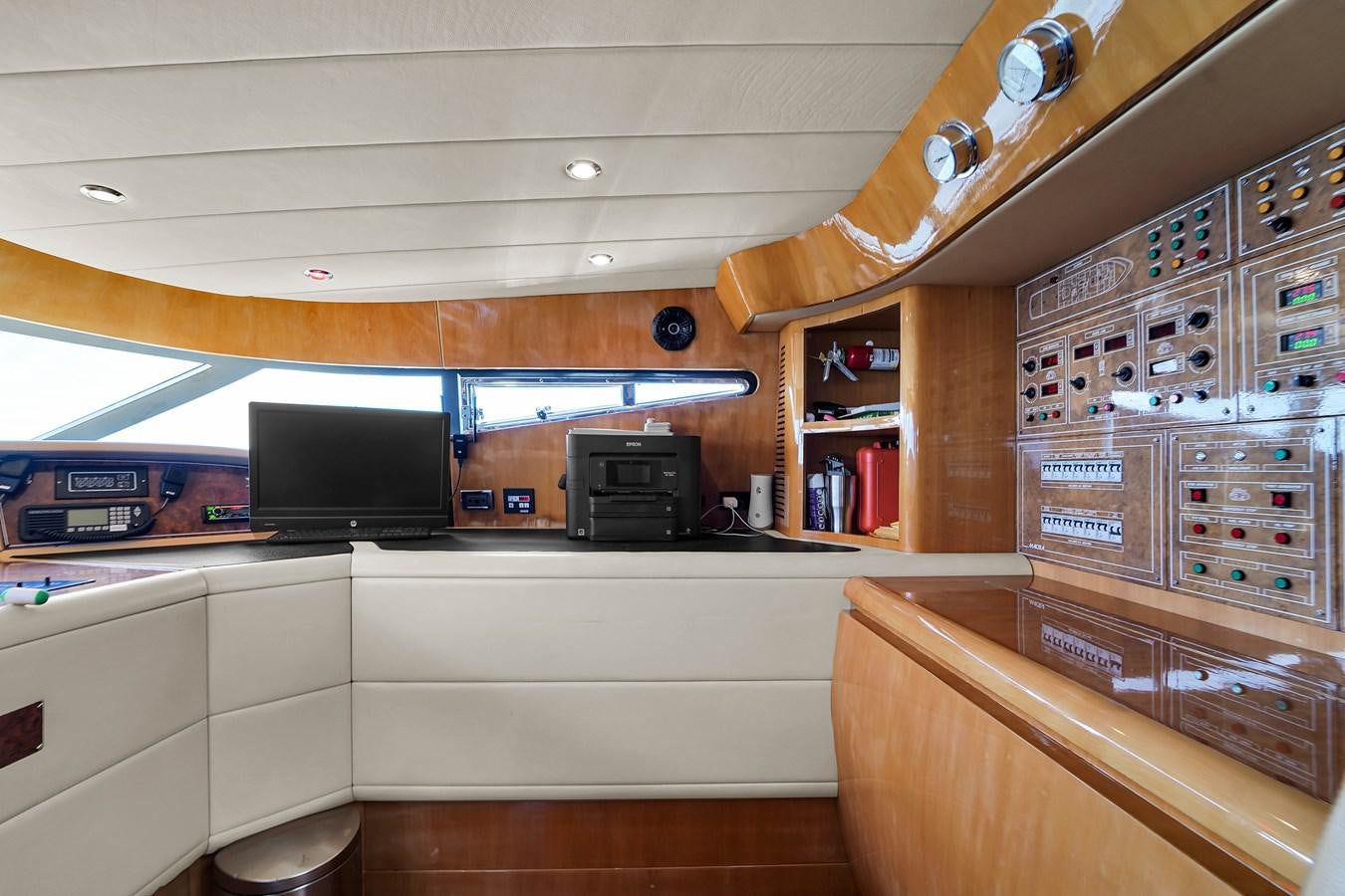 a room with a tv and a shelf with electronics aboard STAMOS BIEN Yacht for Sale