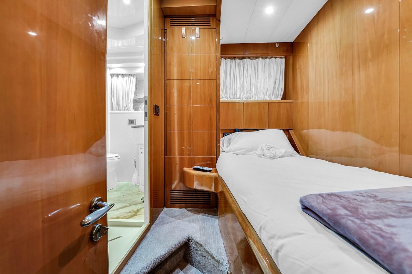 a room with a bed and a mirror aboard STAMOS BIEN Yacht for Sale